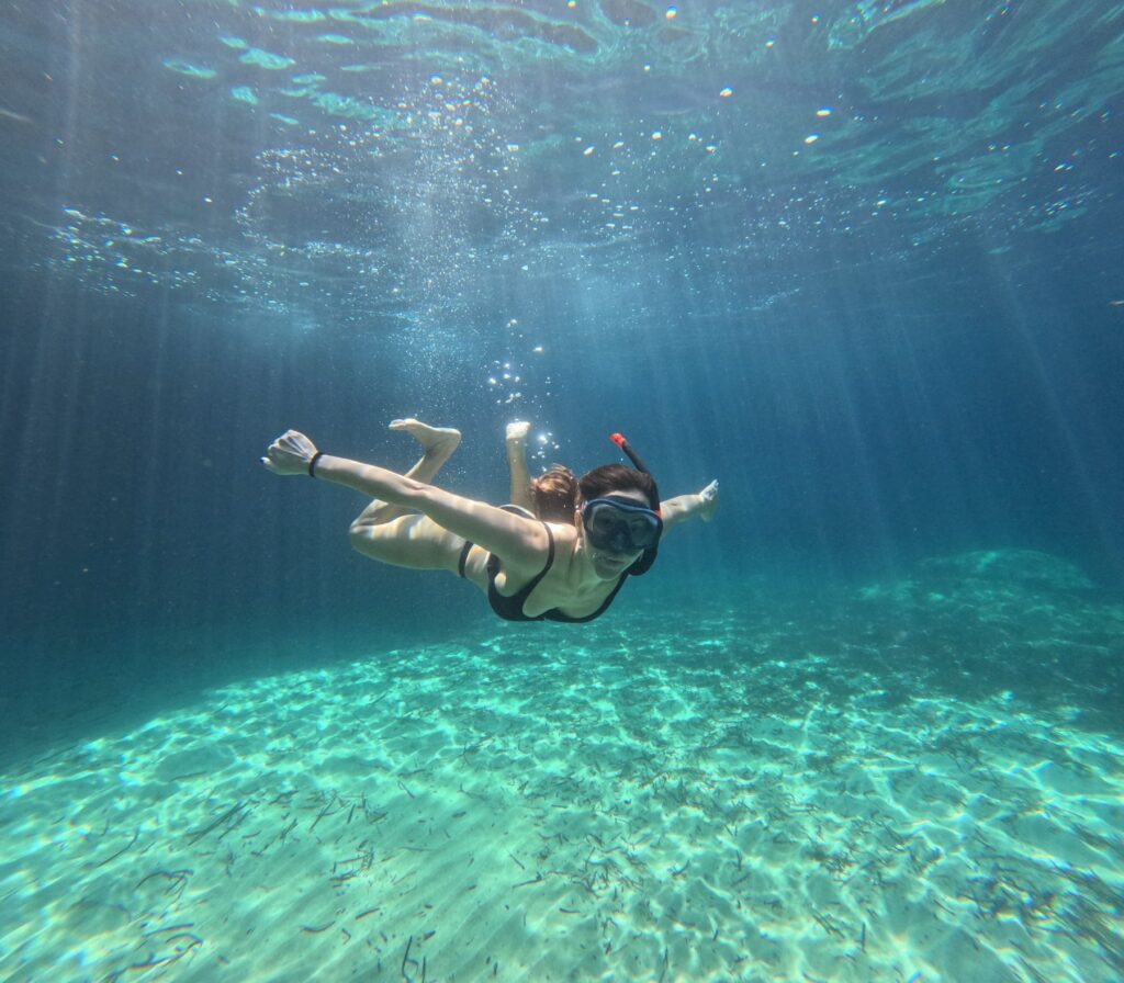 underwater girl milos greece kayak